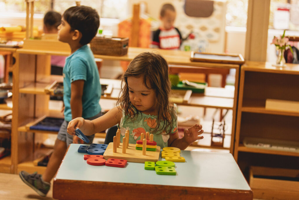 Preschool student working with hands-on Montessori materials in a classroom at Country Montessori School in Poway