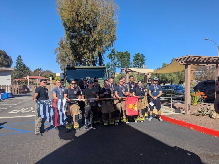 Firefighters and walkers with a flag at the Firefighters for Hope walk at Country Montessori School in Poway