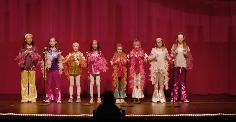 Students in costume performing on stage at the Spring Fling concert